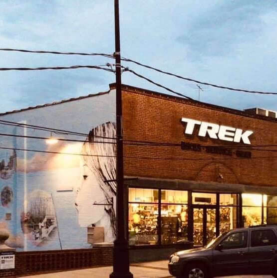 Storefront view of TREK Store in Newnan with mural of woman blowing a bubble
