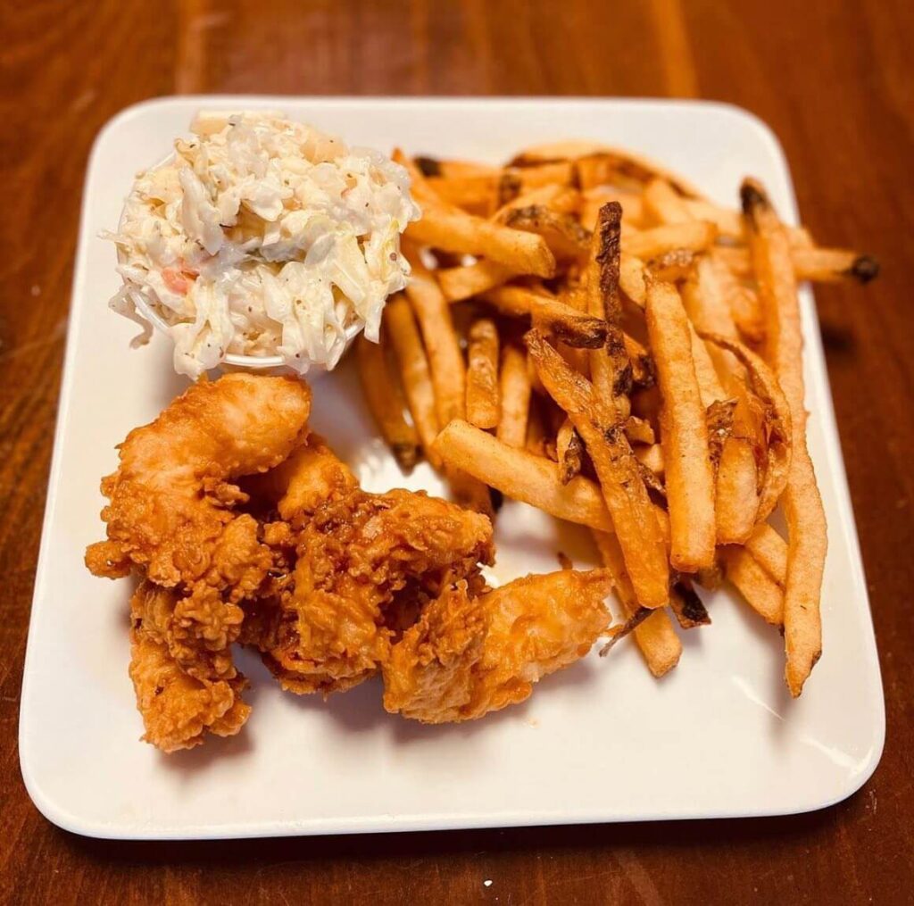 Chicken tenders with cole slaw and french fries