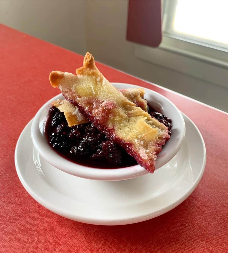 Bowl of blackberry cobbler with pastry crumble
