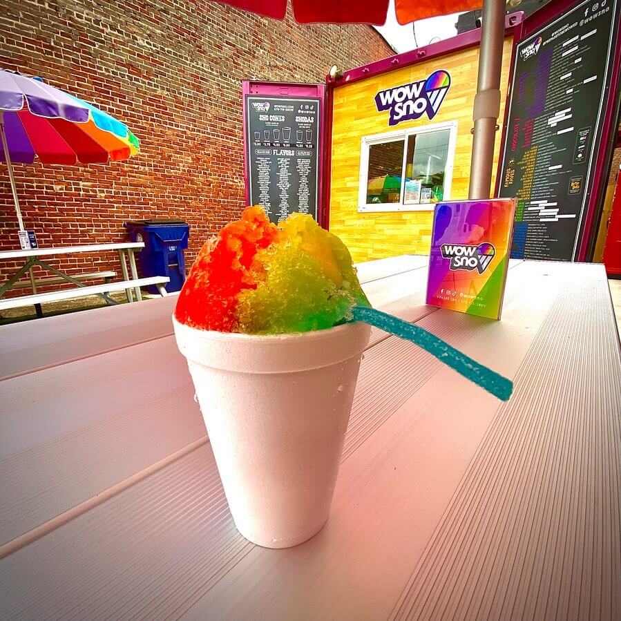 Rainbow sno cone with a sour candy straw