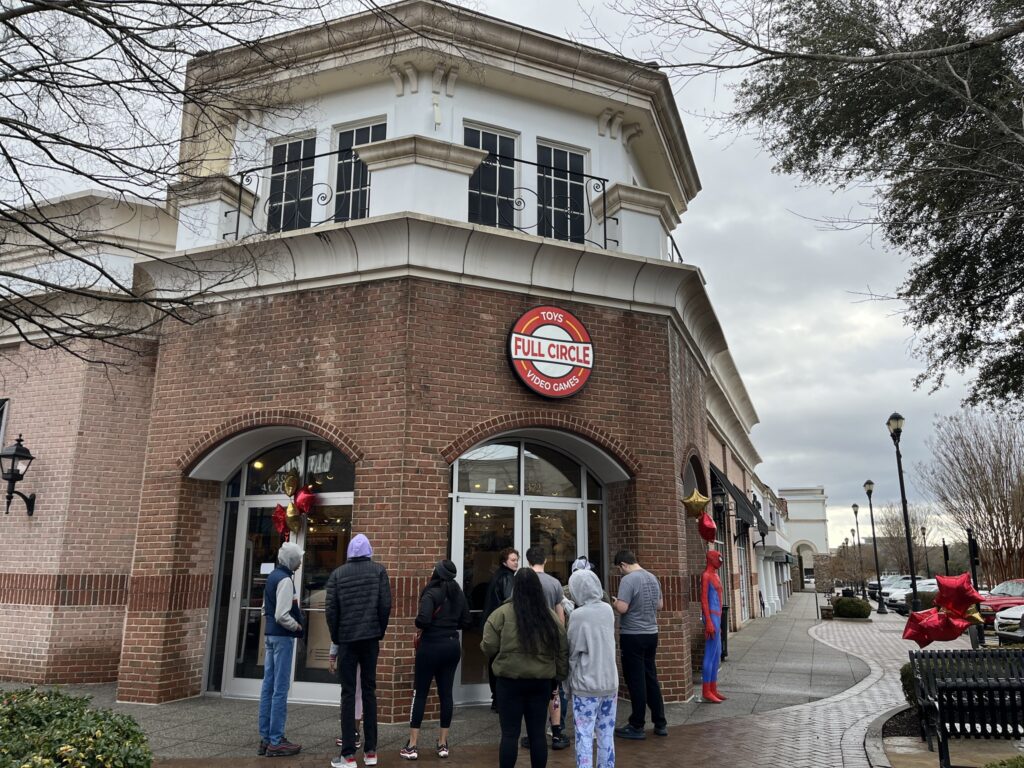 Outside shot of building with a line of people