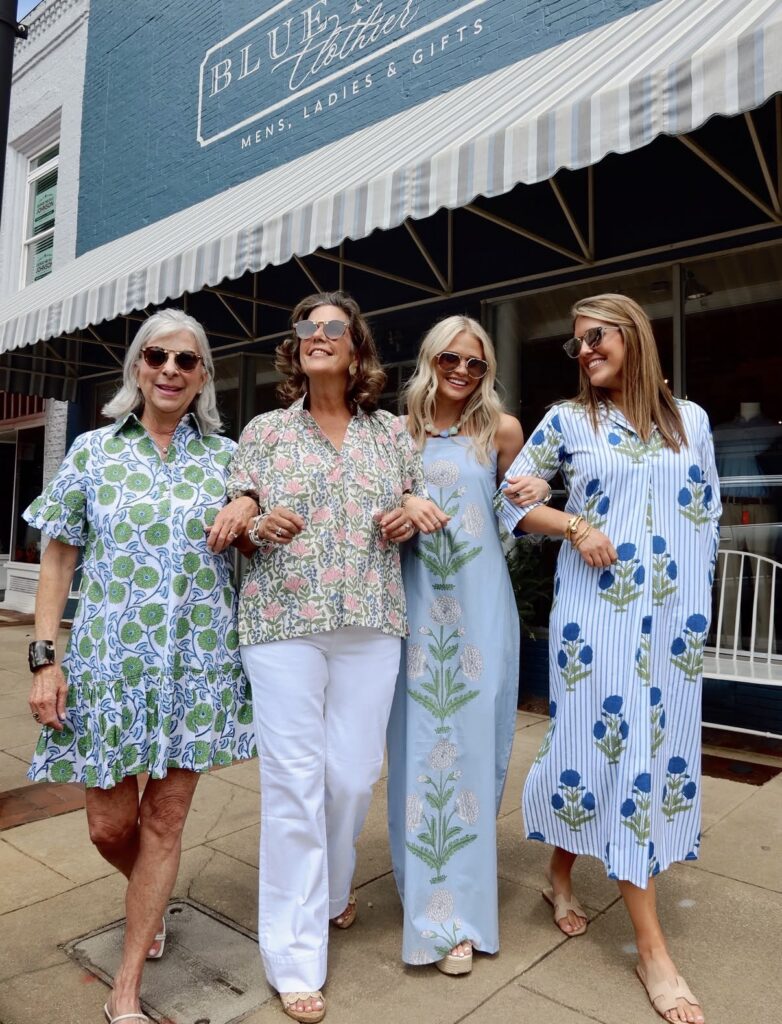 Ladies walking arm in arm outside of boutique
