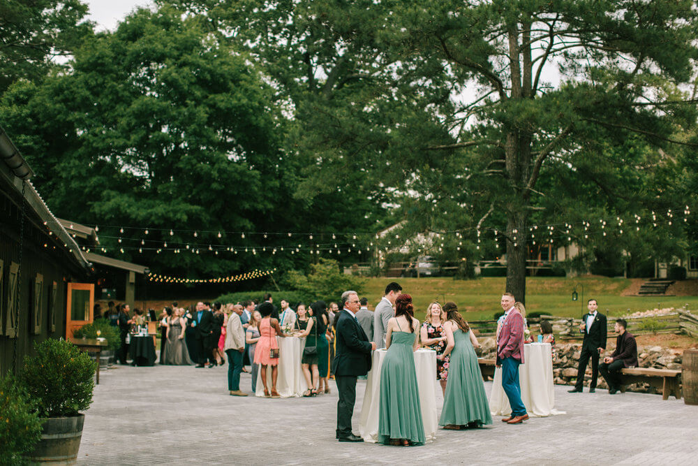 Outdoor wedding reception with charming string lights at Vinewood Stables