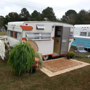 Cute camping trailor with rug out front