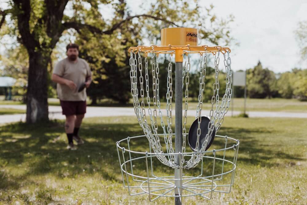 Person playing frisbee golf in a park