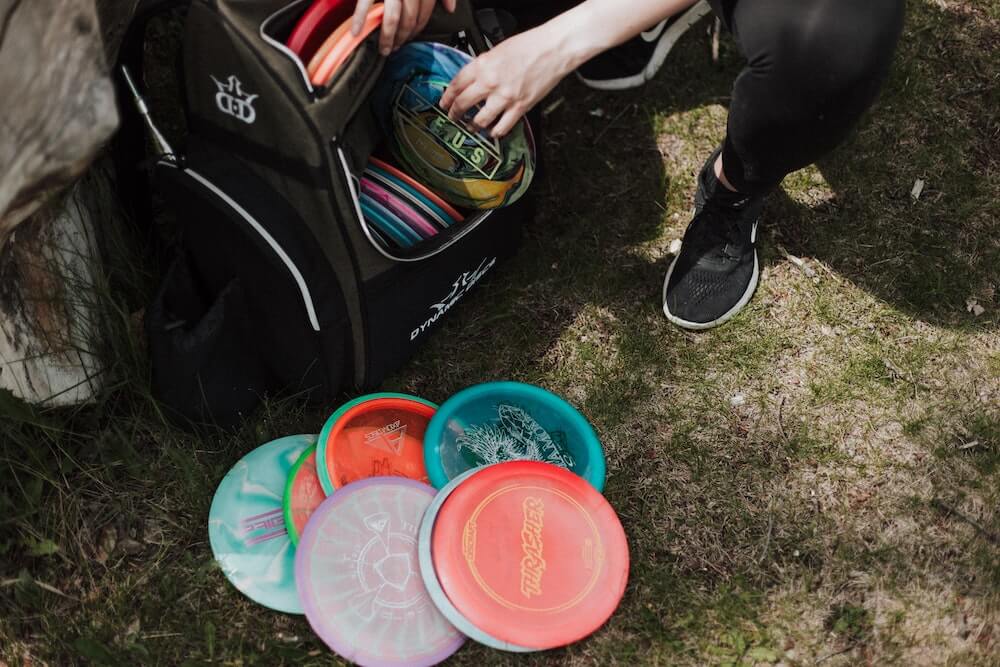 A sports duffel bag with frisbee's spilling out