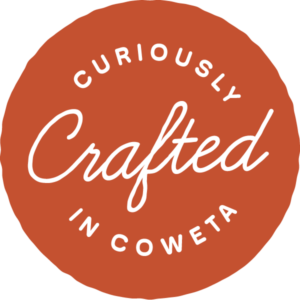 curiously crafted in coweta logo