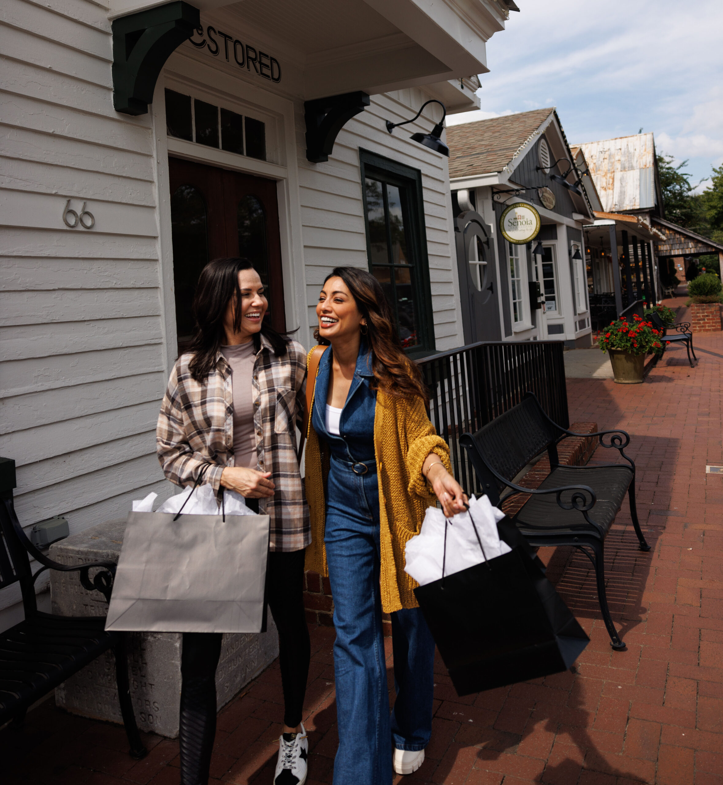 Girls with shopping bags in fall clothes on main street