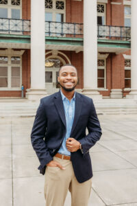 Guy standing in front of courthouse in navy blazer