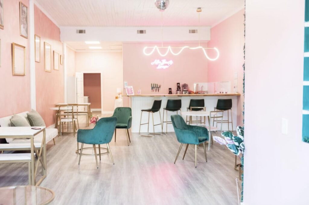 Wide view of spa with pink walls and green chairs