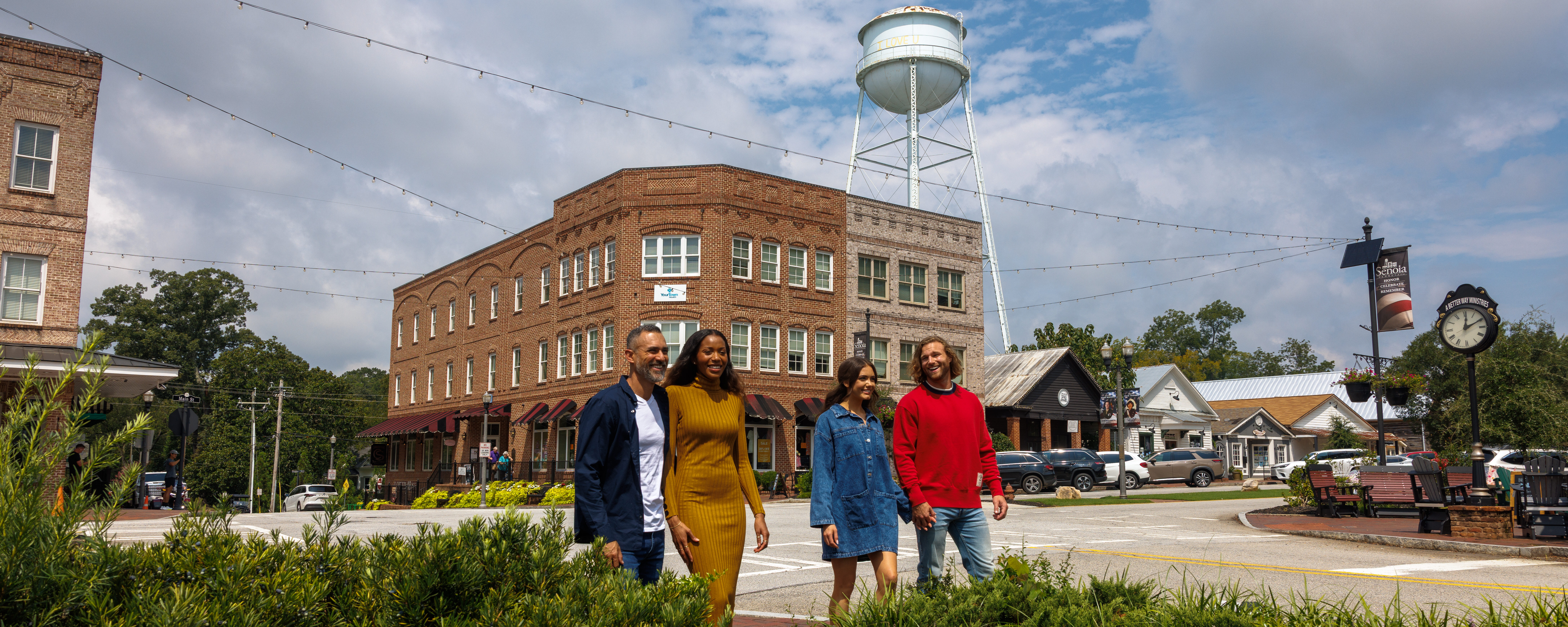 Two couples strolling down Mainstreet in Downtown Senoia