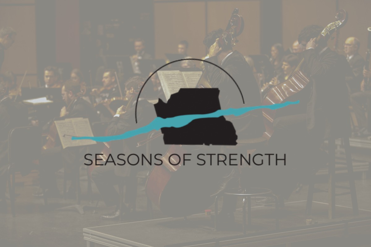 A full orchestra on stage with the Season of Strength logo displayed over the image.
