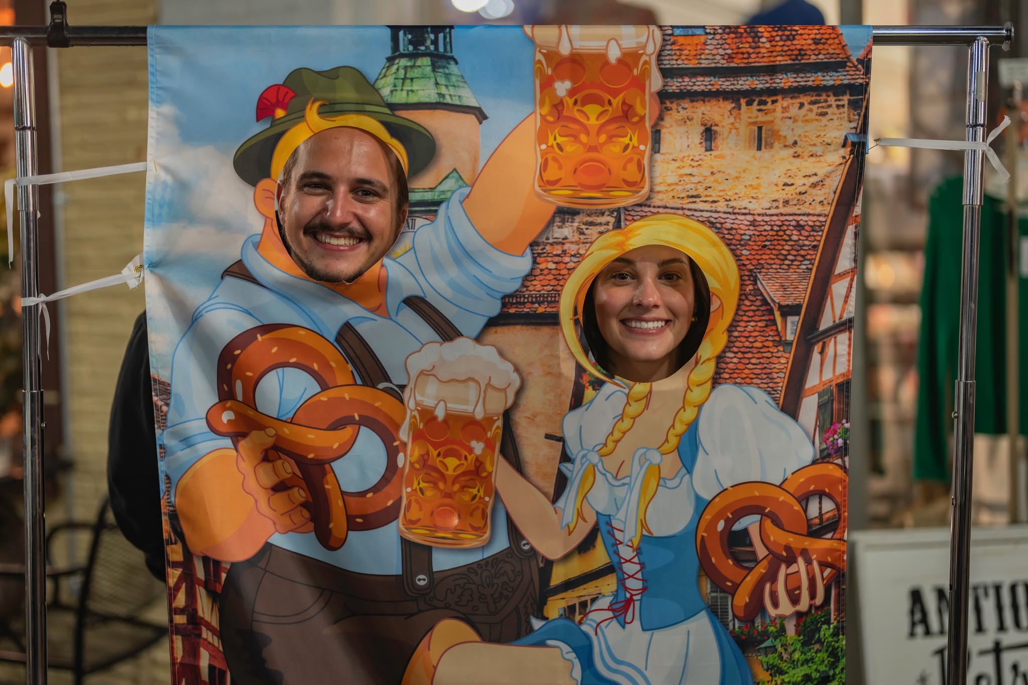 An Oktoberfest-themed photo cutout banner where people can pose with their faces through the cutouts.