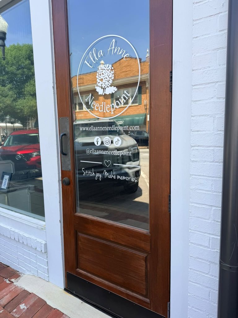 Exterior door shot of Ella Anne Needlepoint storefront.